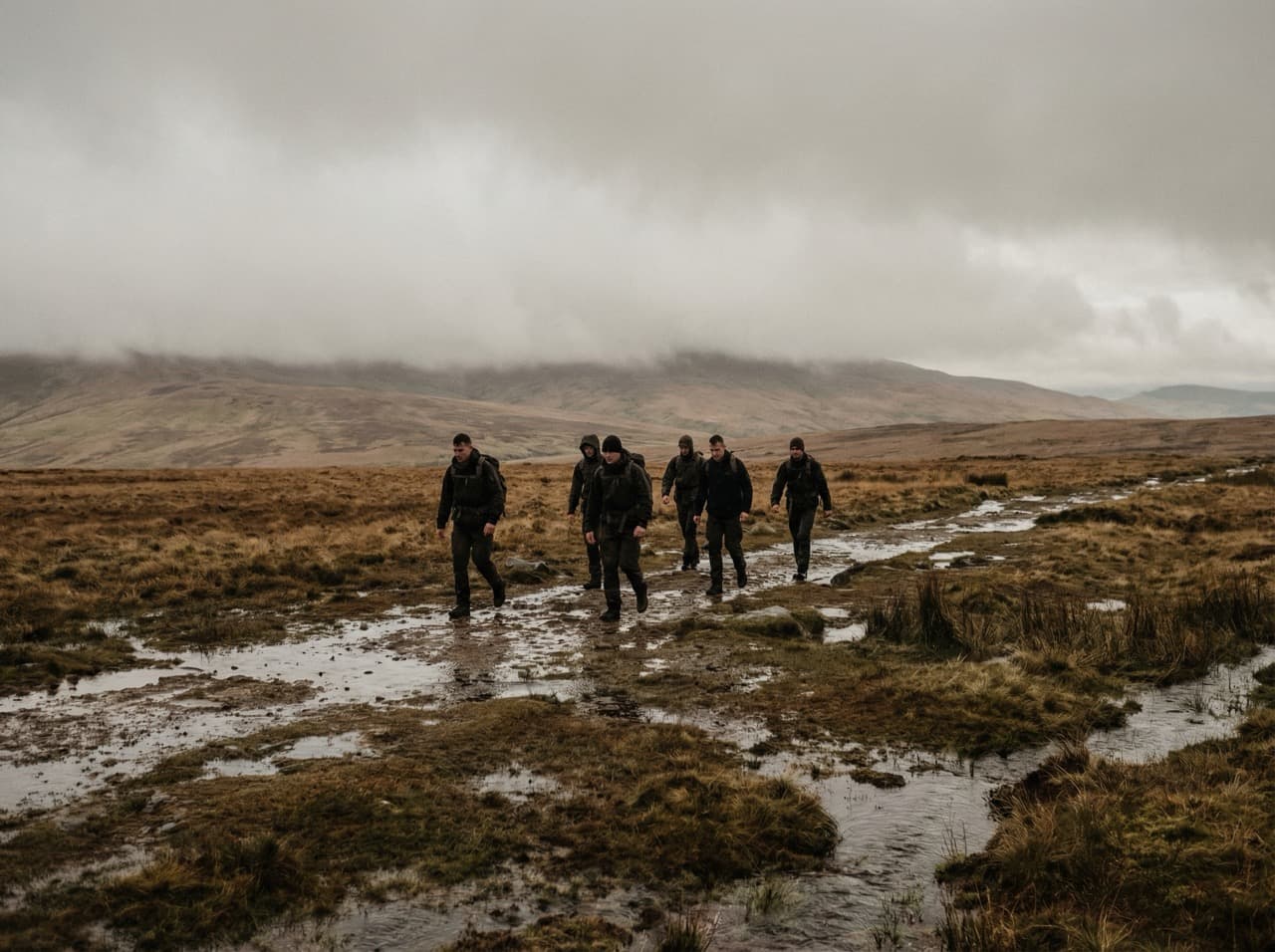 Group walking through remote British moorland in overcast conditions